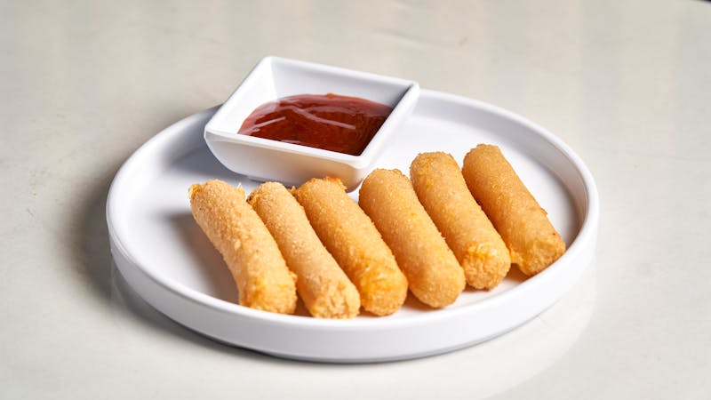 Marinara dipping sauce and cheesy breadsticks side at Via 313